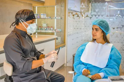 Dentist and patient at a consultation desk reviewing smile design options at a clinic in Turkey